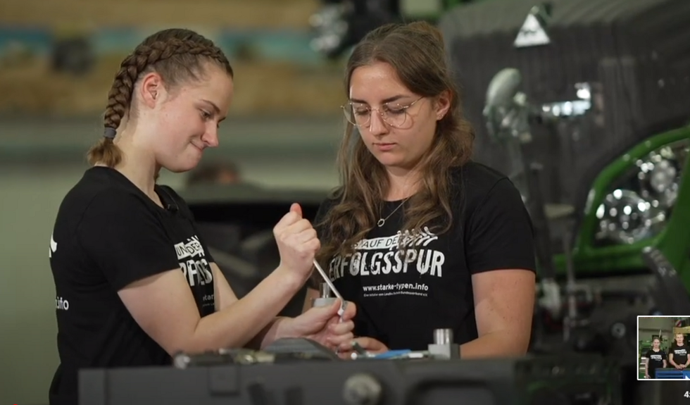 Zwei junge Frauen reparieren eine Maschine